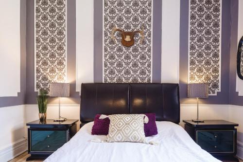 a bedroom with a large bed with two night stands at MtlVacationRentals - Appartements Plateau-Mont-Royal in Montréal