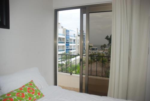 Postel nebo postele na pokoji v ubytování E&J Beach Condo