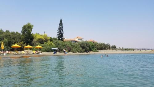 a beach with people swimming in the water at Cyprus Glamping Park in Ayios Theodhoros