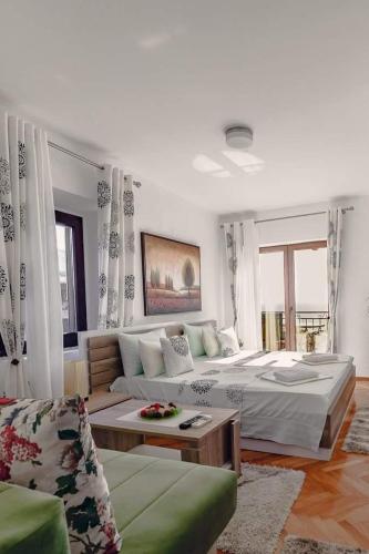 a living room with a large bed and a couch at Apartments Debora in Ulcinj