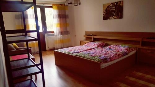 a small bedroom with a bed and a ladder at Pension-Puttlachtal in Pottenstein