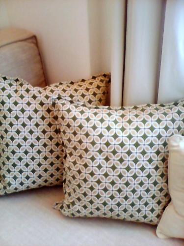 two pillows sitting next to each other on a bed at Studios Anemomilos in Astypalaia Town