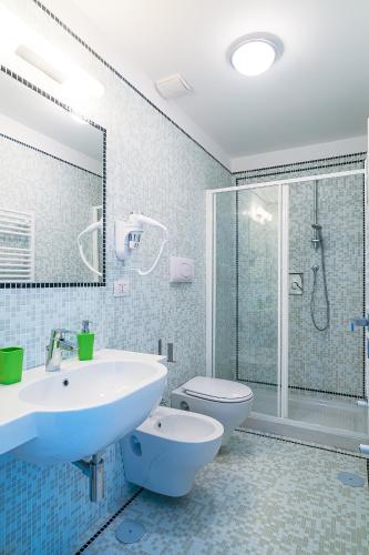 a bathroom with a sink and a toilet and a shower at Donna Giulia, Luxury House in Salerno