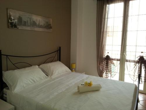 a bedroom with a white bed with a flower on it at Casa Vacanze Chiara in Terrasini