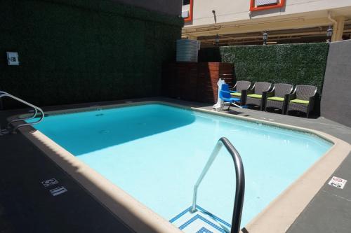 
a swimming pool with a tennis racquet on top of it at BLVD Hotel & Suites - Walking Distance to Hollywood Walk of Fame in Los Angeles
