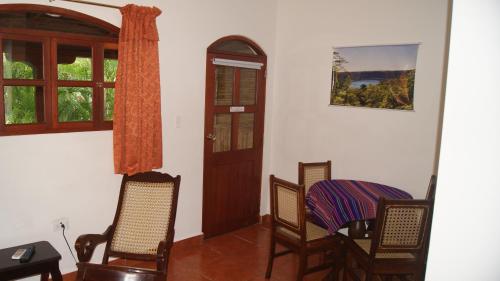 a room with chairs and a table and a door at Hotel Cacique Adiact in León