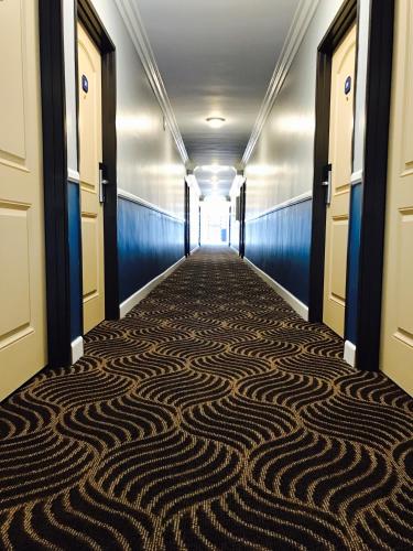 a hallway with a carpet on the floor at Relax Inn in Los Angeles