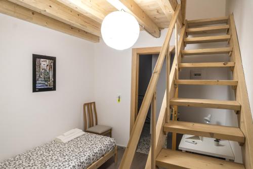 a small room with a staircase and a bed at Al Qatta Bed & Breakfast in Canicattì