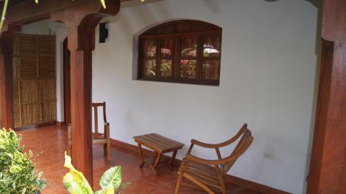 a room with two chairs and a window on a wall at Hotel Cacique Adiact in León