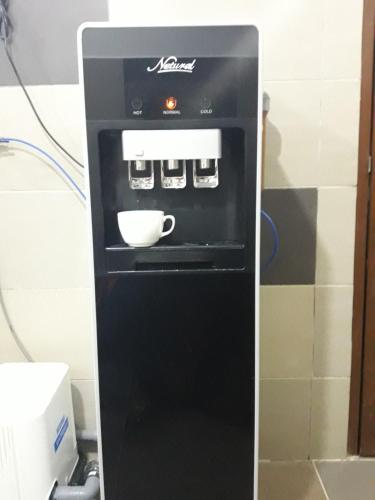 a black oven with a bowl inside of it at Hotel Al Abraar in Melaka