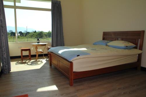 a bedroom with a bed and a large window at Meet Canaan in Xikou