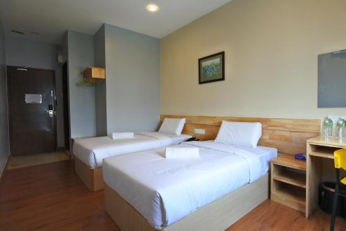 Hotel Dutaria tesisinde bir odada yatak veya yataklar
