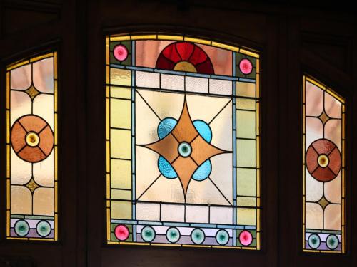 a pair of stained glass windows on a wall at Penghana Bed and Breakfast in Queenstown