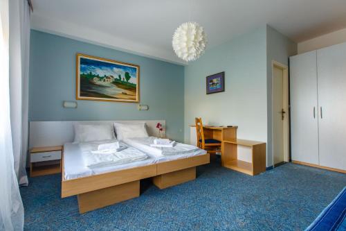 a bedroom with a bed and a desk in it at Rooms Split in Split