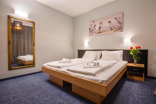 a bedroom with a bed with a mirror and a sink at Rooms Split in Split