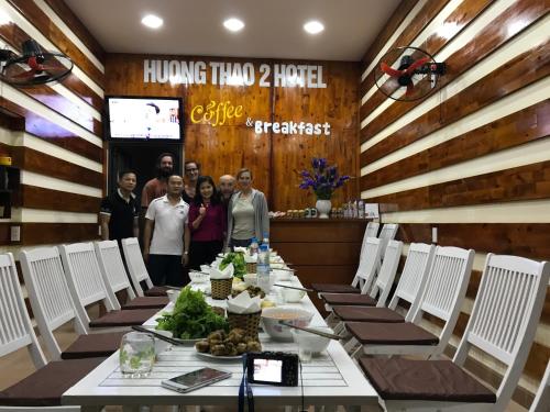 a group of people standing around a long table at Huong Thao 2 Hotel in Ha Giang