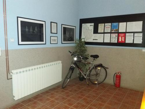 a bike parked in a room with a wall at Kafana Zlatna Ribica in Golubac