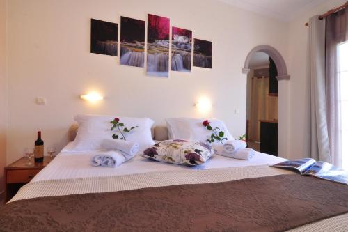 a bedroom with a bed with towels on it at Rolandos Apartments in Agios Gordios