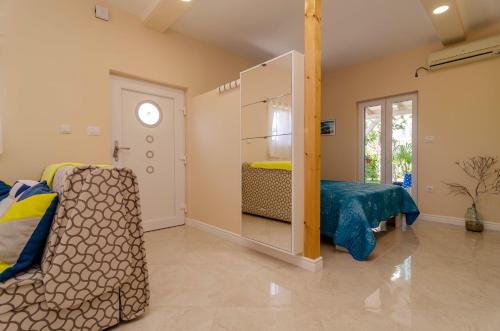 a room with a bedroom with a bed and a door at Beachfront House with Private Jacuzzi and Garden Zadar in Zadar