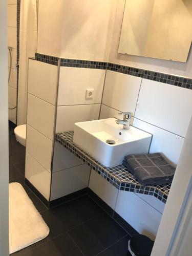 a bathroom with a sink and a toilet at Appartment am Nordpark in Mönchengladbach