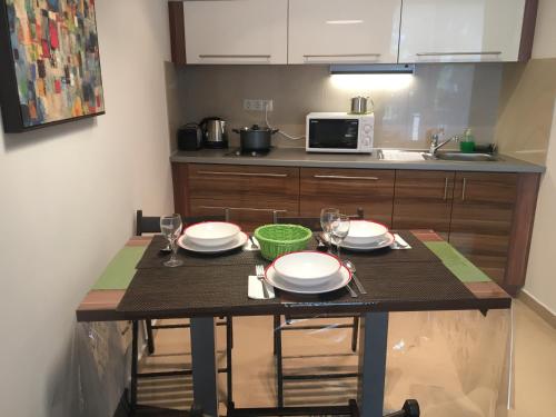 a kitchen with a table with plates and glasses on it at Villa Mona Lisa in Hévíz