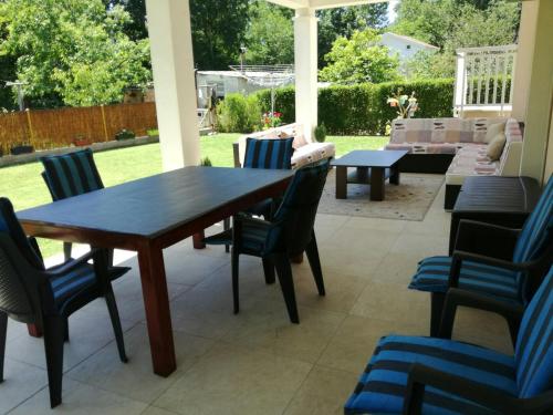 a patio with a wooden table and chairs at Riverside Guesthouse in Počitelj