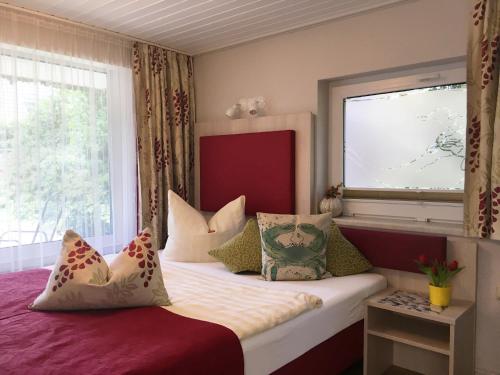a bedroom with a large bed with a window at Pension Inselparadies Zingst in Zingst