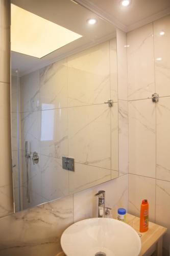 a bathroom with a sink and a shower at Artemis Village Apartments & Studios in Stavros
