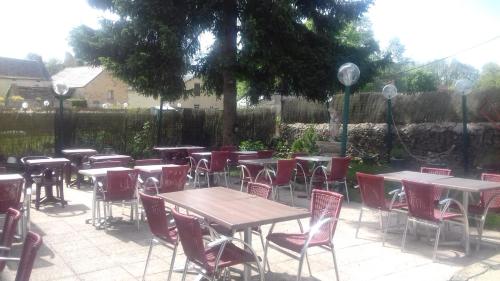 a group of tables and chairs in a patio at Auberge Du Bon Coin in Moulins-Engilbert