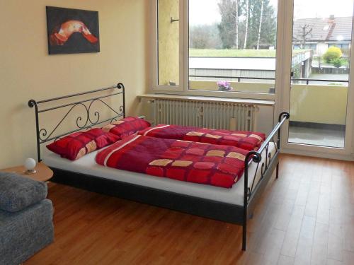 メーアスブルクにあるFerienapartment Blumeのベッドルーム1室(赤い毛布付きのベッド1台付)