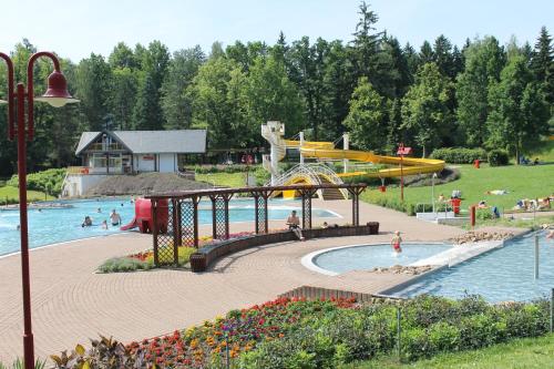 a water park with a water slide and people in it at Hotel BB Bahnhof Bertsdorf in Olbersdorf