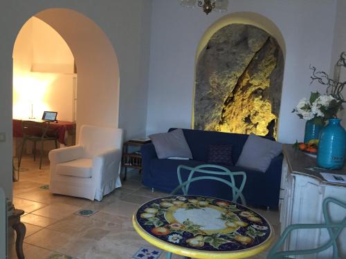 a living room with a blue couch and a table at La Casa di Vania in Ravello