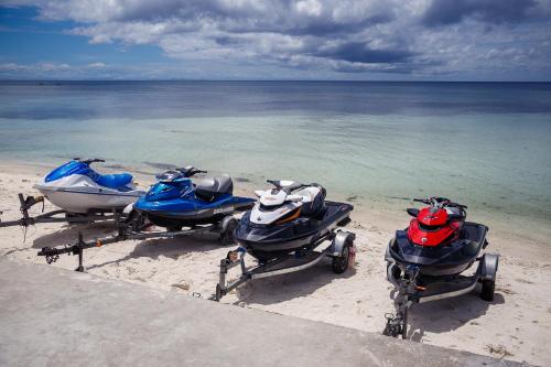 a group of three motorcycles parked on the beach at Tropical Fun Ta Sea Rentals in Siquijor
