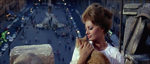 a woman is eating a sandwich in a city at Navona 49 Luxury Suites&Apartment in Rome