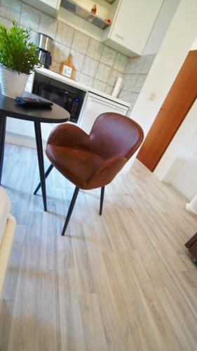 a brown chair sitting next to a table in a kitchen at GL 234 in Bergisch Gladbach