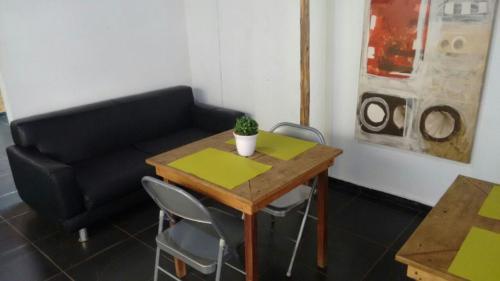 a living room with a table and a couch at Hotel Aldeia Cerrado in Goiânia