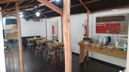 a restaurant with tables and chairs in a room at Hotel Aldeia Cerrado in Goiânia
