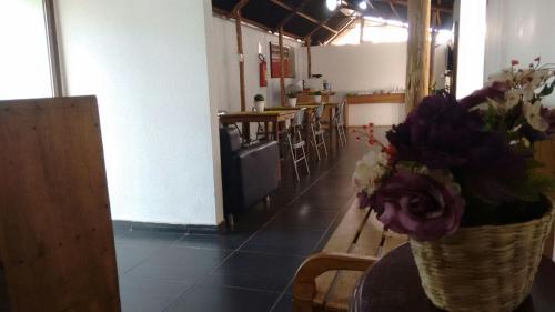a vase of flowers sitting on a table in a restaurant at Hotel Aldeia Cerrado in Goiânia