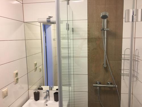 a bathroom with a shower and a sink at Villa Mona Lisa in Hévíz