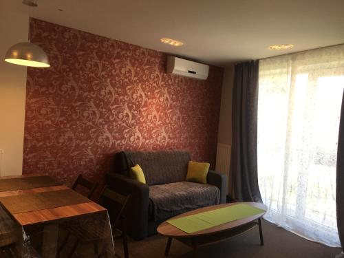 a living room with a couch and a table at Villa Mona Lisa in Hévíz