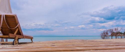 a beach chair sitting on top of a sandy beach at S4Sani in Sani Beach