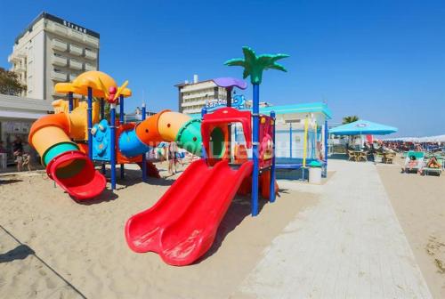 a playground with a slide on the beach at Atene Albergo Riccione in Riccione