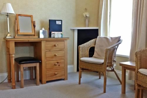 a room with a desk with a mirror and a chair at The Baytree - Exclusively for Adults in Torquay