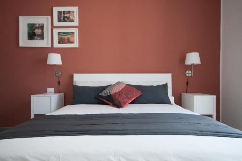 a bedroom with a large bed with red walls at B&B Dietro il Teatro in Palermo