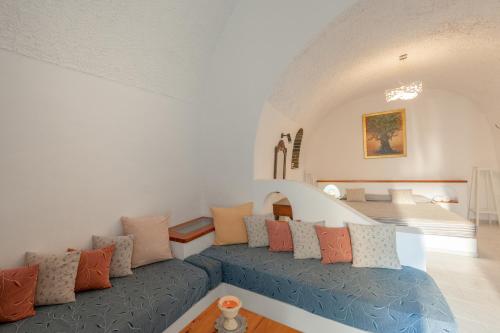 a living room with a couch with pillows at Vallas Apartments & Villas in Firostefani