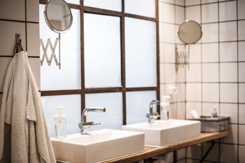 a bathroom with two sinks and a mirror at Woodah Boutique Hostel in Copenhagen