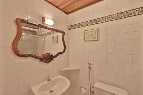 a bathroom with a sink and a mirror at Pousada do Amparo in Olinda