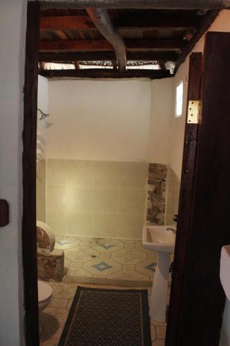 a bathroom with a sink and a toilet at La Casita Nica in San Diego