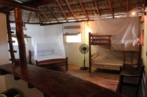 a room with two bunk beds and a table at La Casita Nica in San Diego