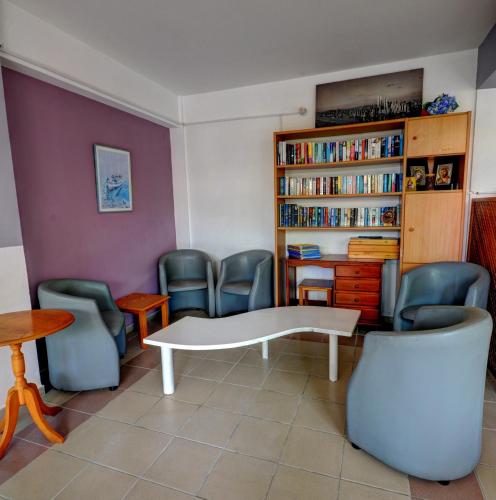 a waiting room with a white table and chairs at Renos Apartments in Polis Chrysochous
